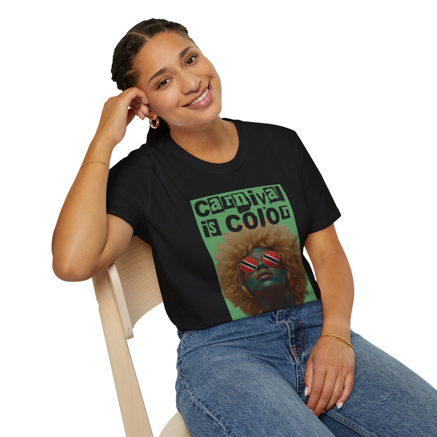 Woman wearing a black Carnival is Color Trinidad and Tobago t-shirt, sitting in front of a white background