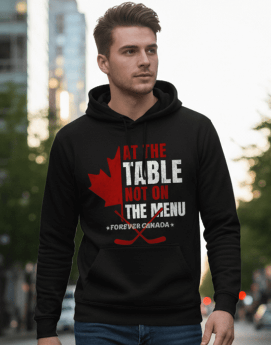 Man wearing a black hoodie with a red and white graphic design outdoors. We are at the table not on the menu