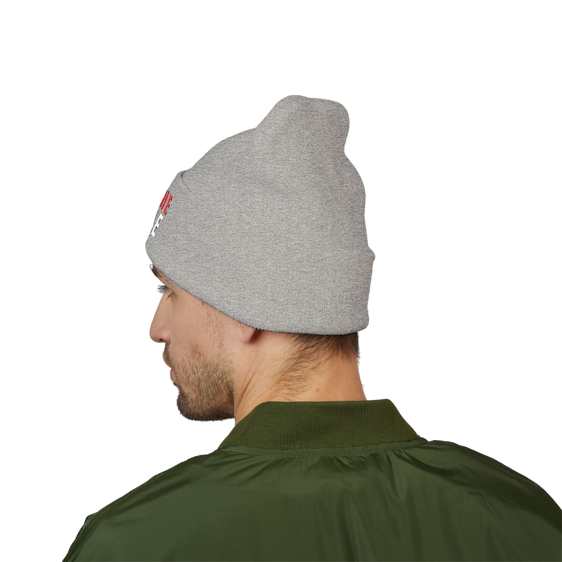 Person wearing a gray beanie with a logo on a white background