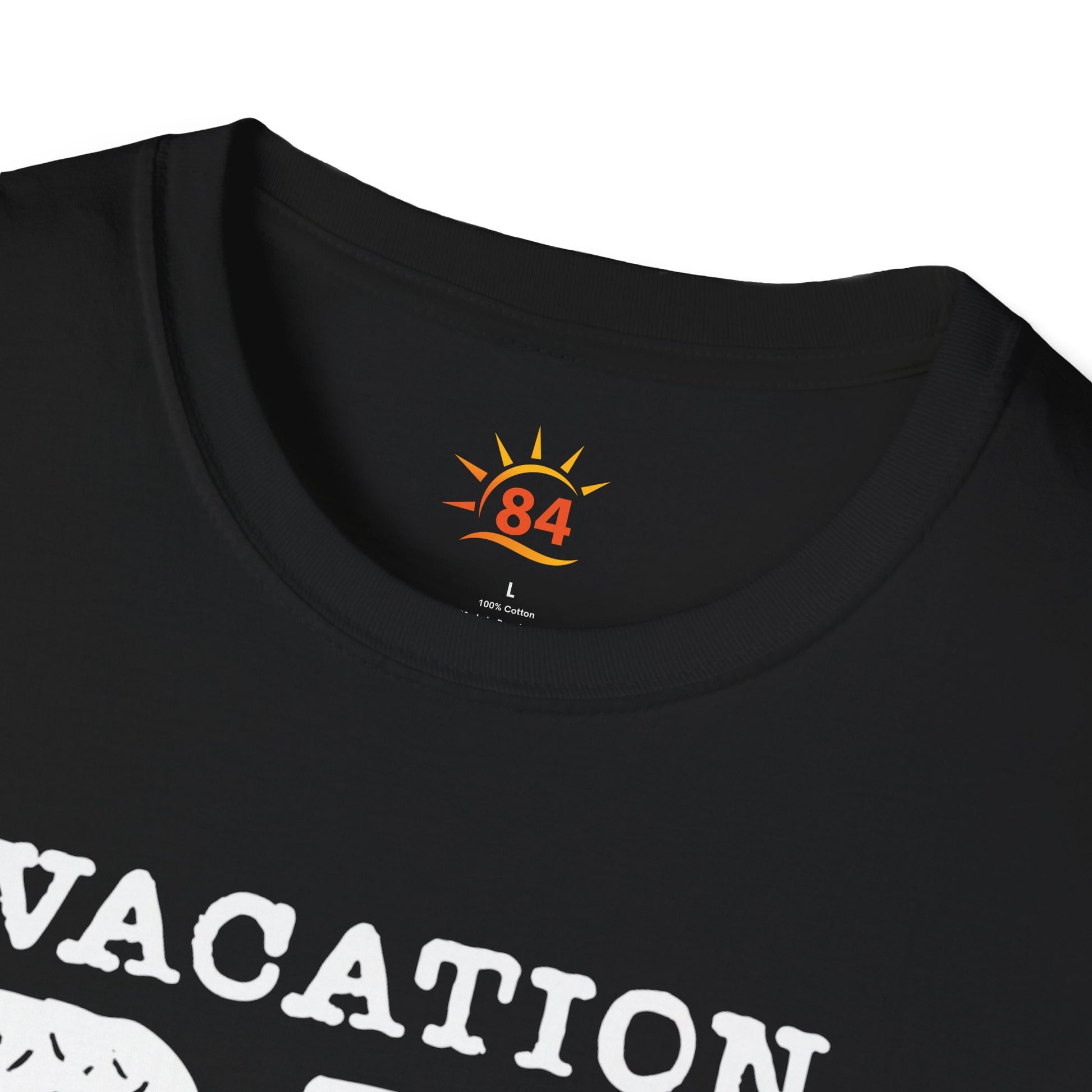 A folded black t-shirt with 'VACATION DAD CHECKLIST' text and bold text and graphics