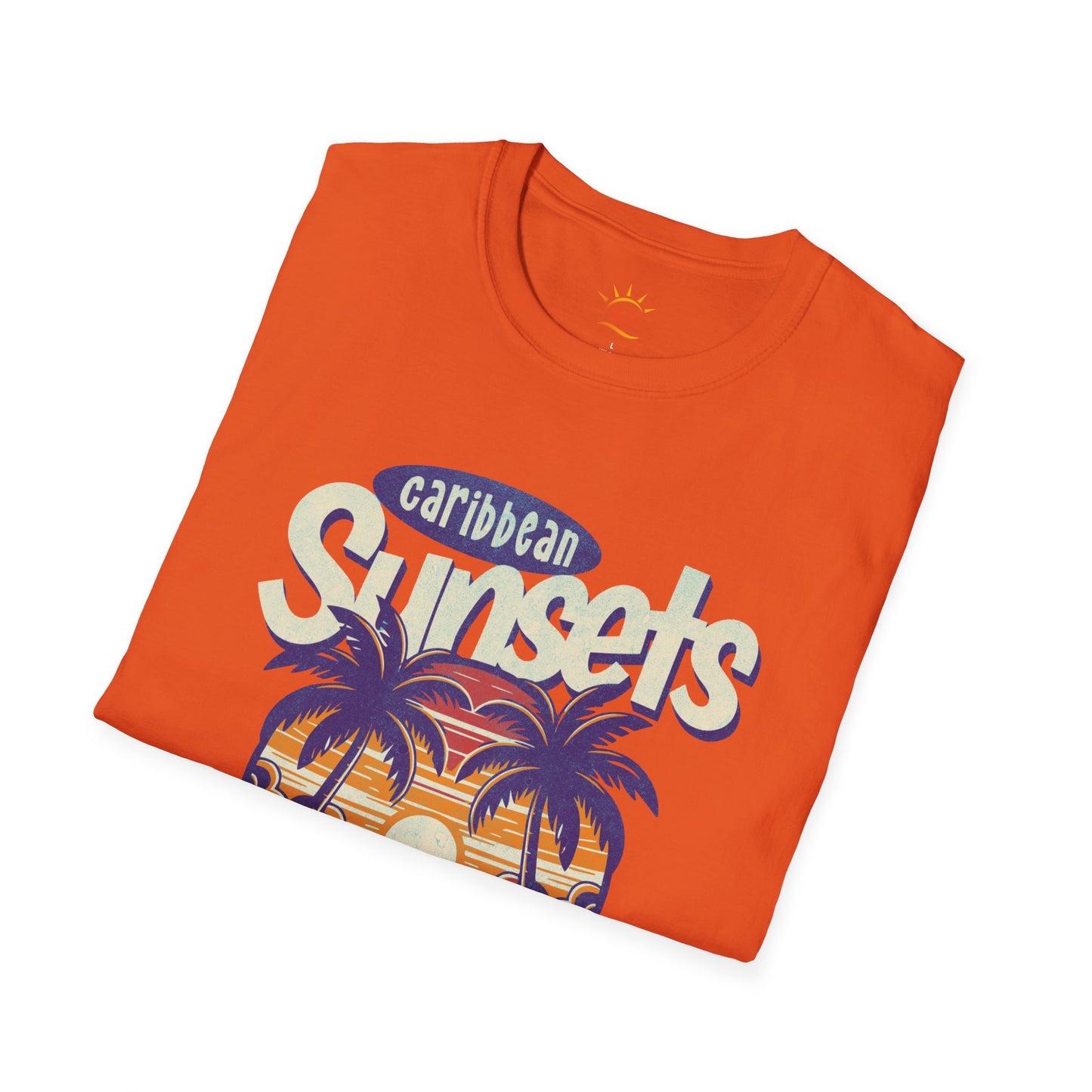 A folded orange t-shirt that says Caribbean Sunsets, Rum Punch Dreams with a beach sunset graphic.