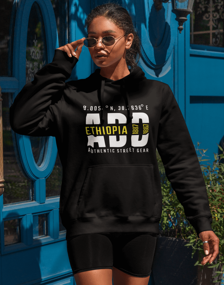 Woman wearing a black hoodie with Addis Ababa, Ethiopia, ADD Airport code and coordinates on a blurred background