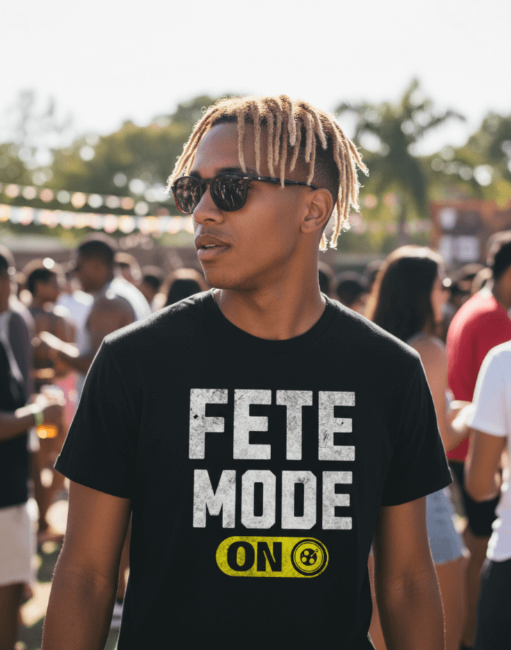 Man wearing a black t-shirt with 'Fete Mode ON' text at a festive outdoor event.