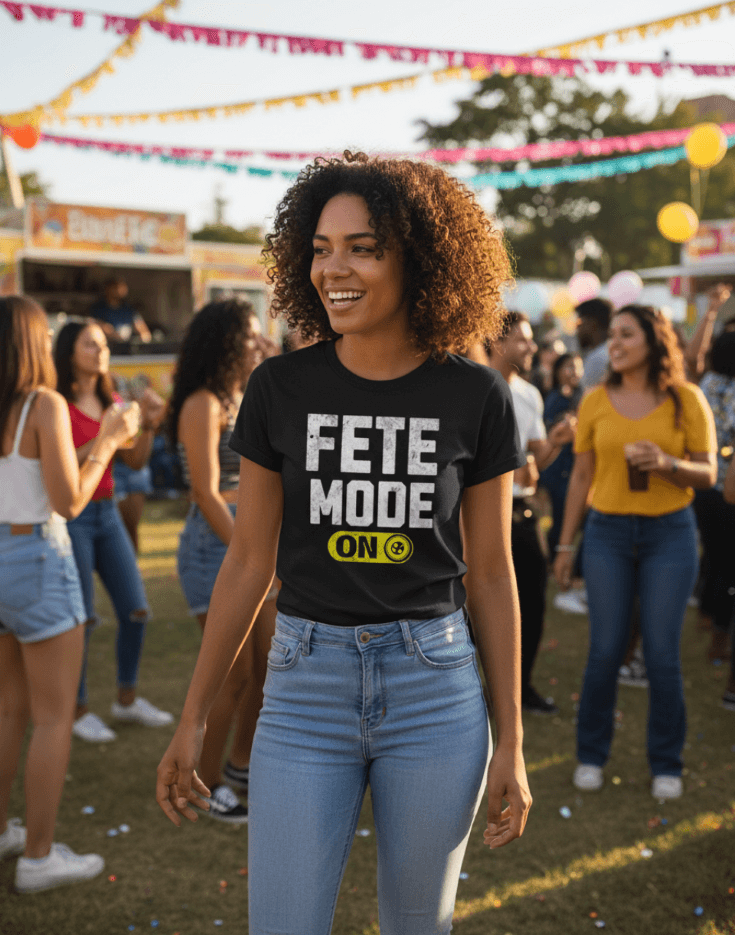 Woman wearing a black t-shirt with 'Fete Mode ON' text at a festive outdoor event.