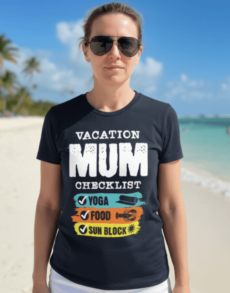 Woman wearing a navy blue t-shirt with 'VACATION MUM CHECKLIST' text and bold text and graphics