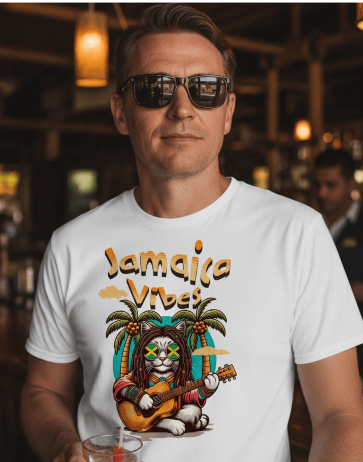 Man standing in a bar wearing a white t-shirt with Jamaica Vibes text and Jamaica flag reggae inspired graphic. 