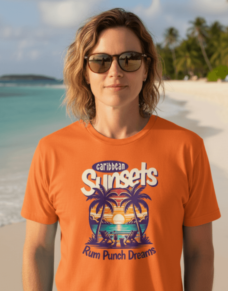Woman on the beach wearing an orange t-shirt that says Caribbean Sunsets, Rum Punch Dreams with a beach sunset graphic.