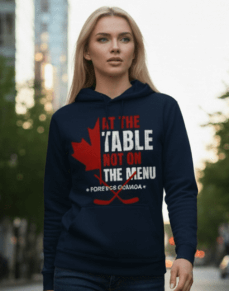 A woman outdoors wearing navy blue hoodie with a red and white graphic design. We are at the table not on the menu