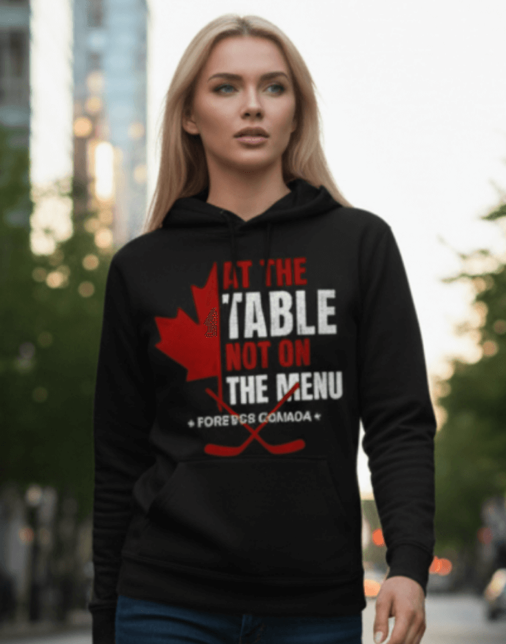 Woman wearing a black hoodie with a red and white graphic design outdoors. We are at the table not on the menu
