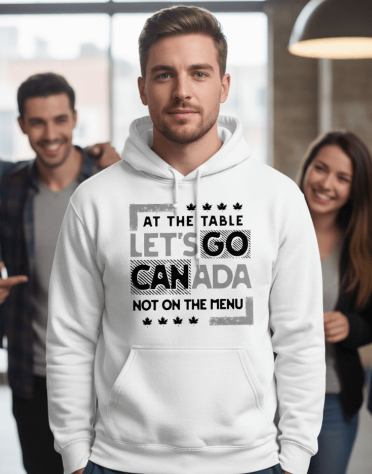Man wearing a white hoodie with text design, At the table, Let's go Canada, Not on the menu, standing indoors.