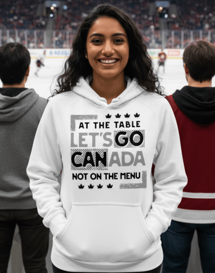 Woman wearing a white hoodie with text design, At the table, Let's go Canada, Not on the menu, standing indoors at a hockey match