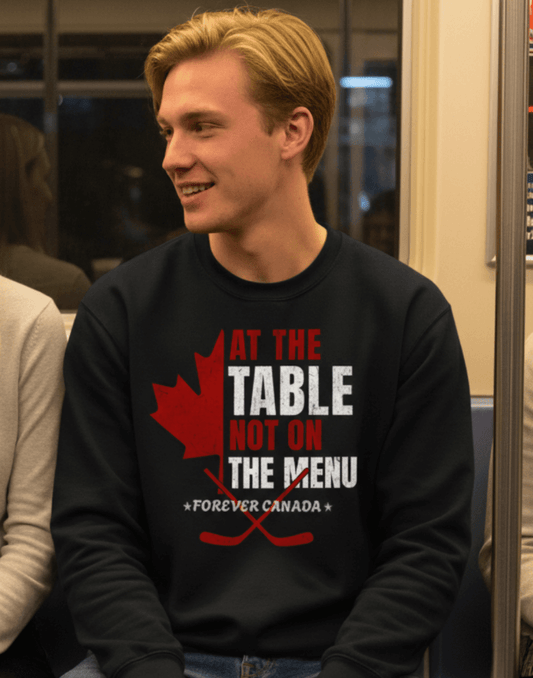 Man wearing a black sweatshirt with a red and white graphic design on a train. We are at the table not on the menu