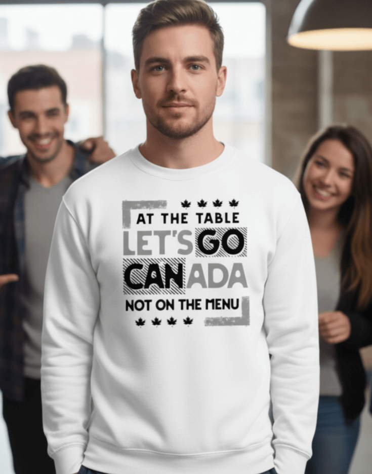 Man wearing a white sweatshirt with text, At the table, Let's Go Canada, Not on the menu, in an indoor setting
