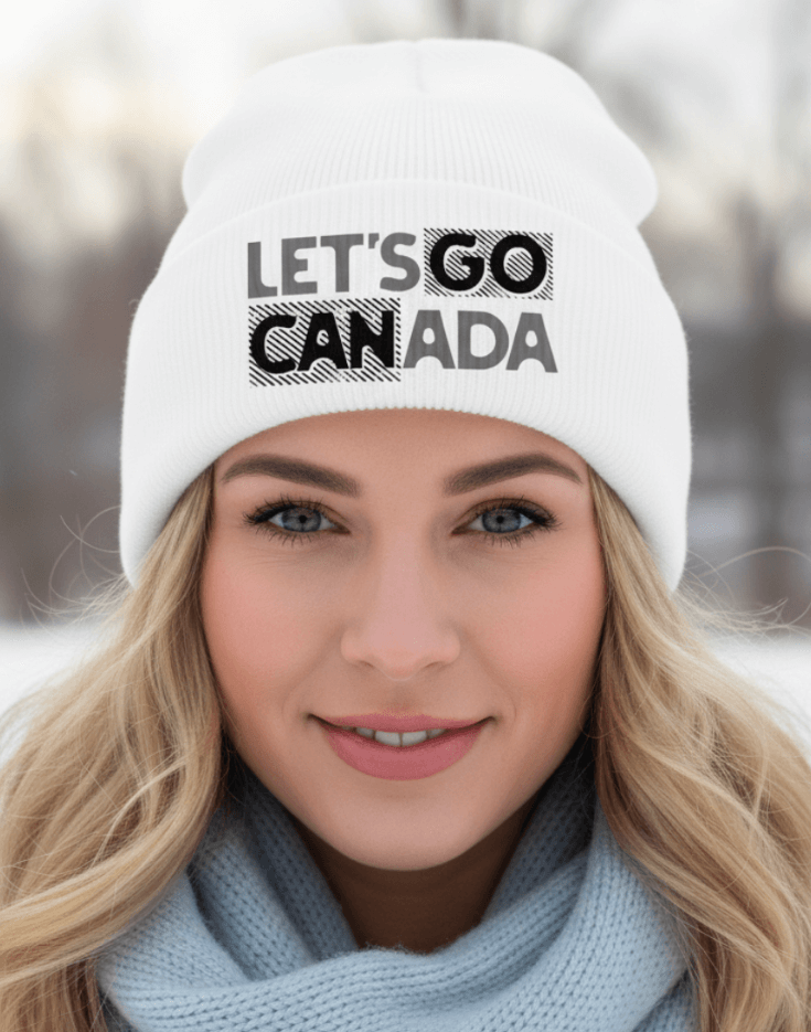Woman wearing a white beanie with 'LET'S GO CANADA' text in a snowy setting