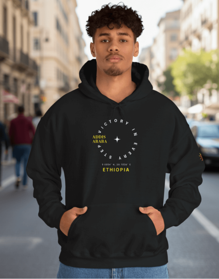 Man wearing a black Ethiopia Addis Ababa hoodie with a design on a city street
