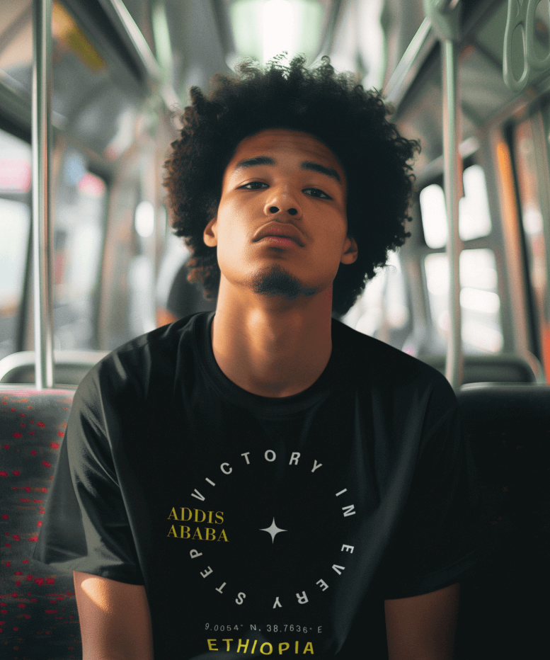 Man wearing a black Ethiopian Addis Ababa t-shirt with minimalist text, sitting on a bus