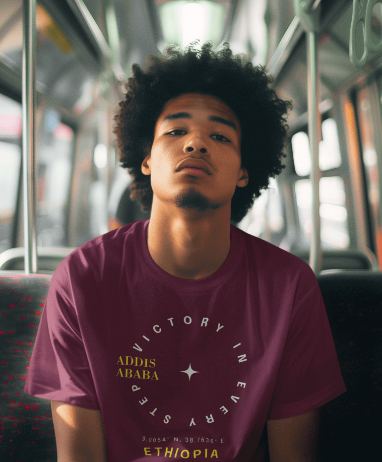 Man wearing a Maroon Red Ethiopian Addis Ababa t-shirt with minimalist text sitting on a bus