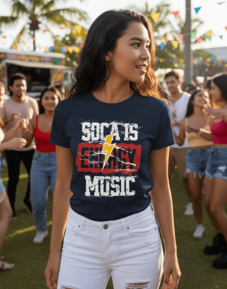 Woman wearing a navy blue 'Soca is Energy Music' t-shirt at a Carnival outdoor event with palm trees.