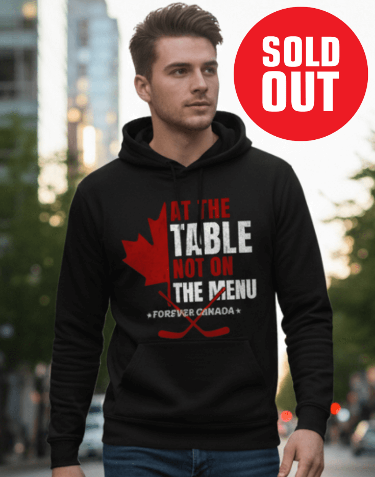 Man wearing a black hoodie with a red and white graphic design outdoors. We are at the table not on the menu