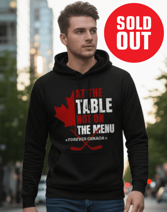 Man wearing a black hoodie with a red and white graphic design outdoors. We are at the table not on the menu