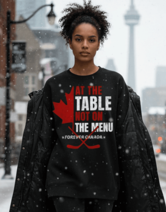 Woman wearing a black sweatshirt with red and white text and graphics, we are at the table not on the menu, standing in a snowy urban setting.