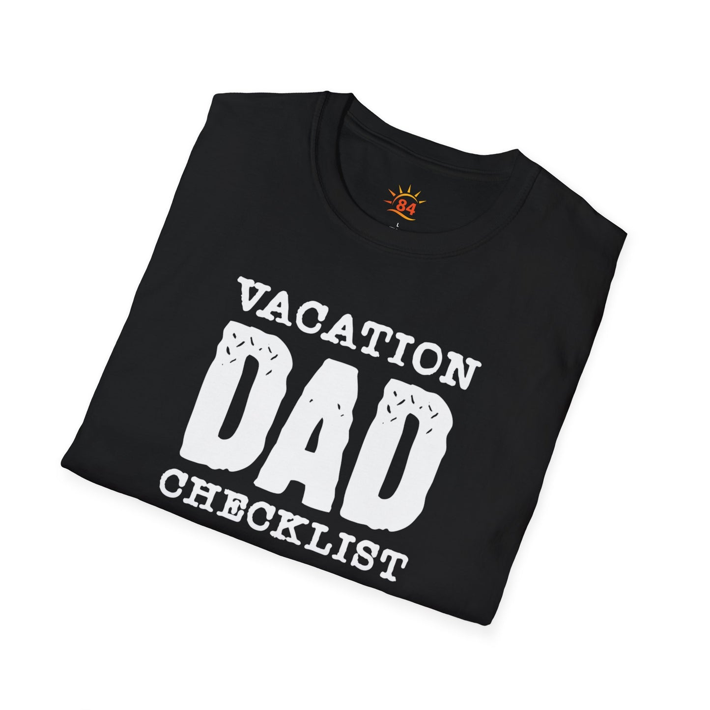 A folded black t-shirt with 'VACATION DAD CHECKLIST' text and bold text and graphics