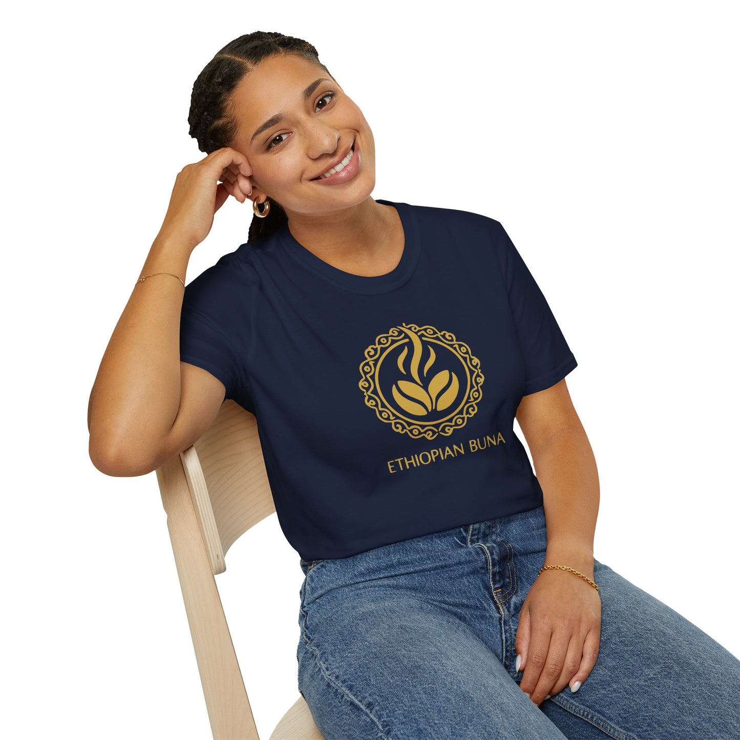 A woman wearing a navy blue Ethiopian Buna graphic print t-shirt sitting in a chair