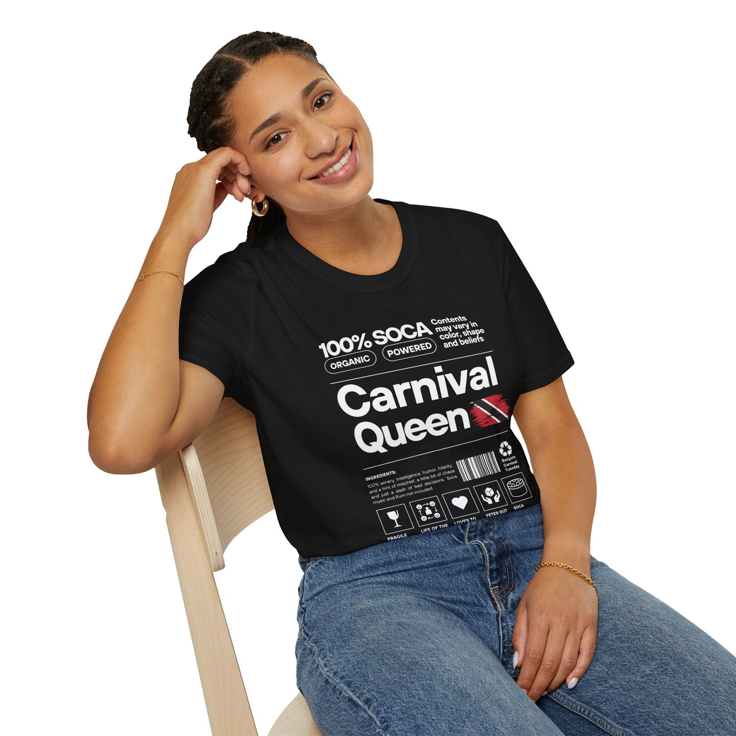 Woman wearing a black t-shirt with 'Carnival Queen' text and graphics, sitting on a chair.