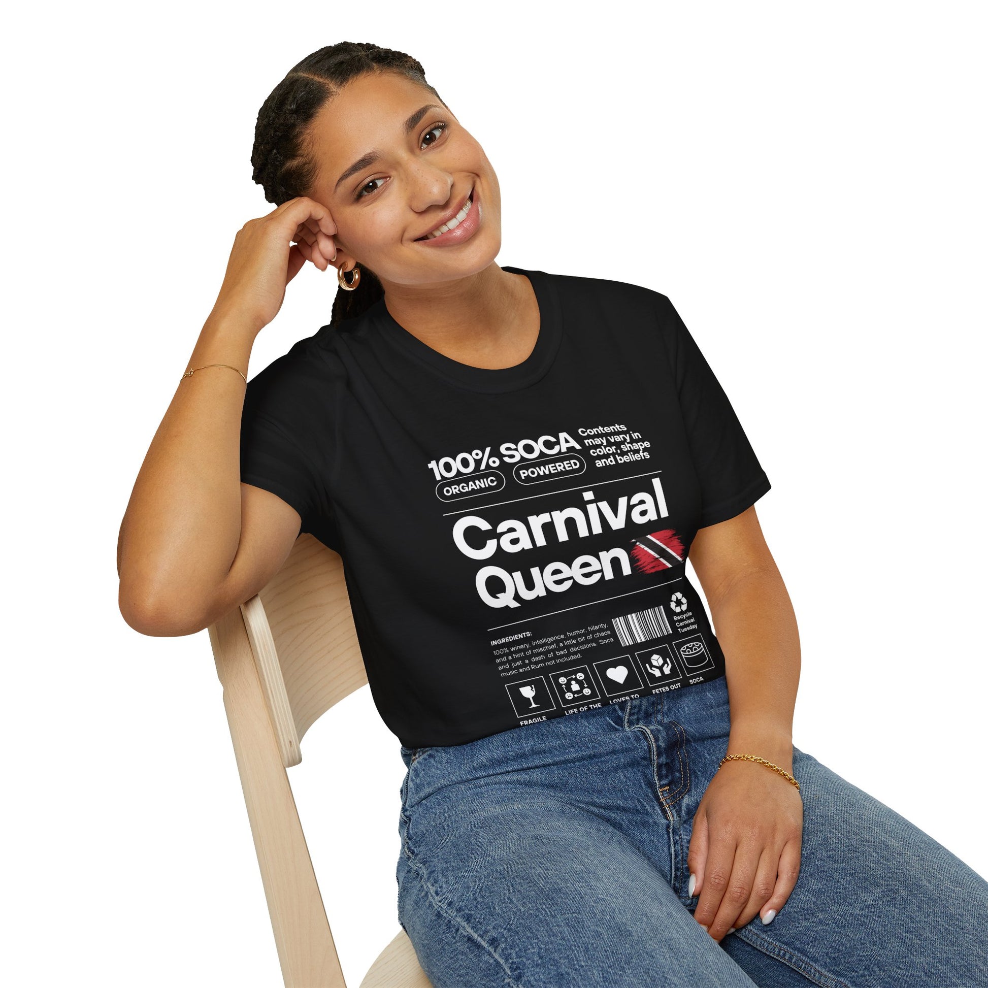 Woman wearing a black t-shirt with 'Carnival Queen' text and graphics, sitting on a chair.