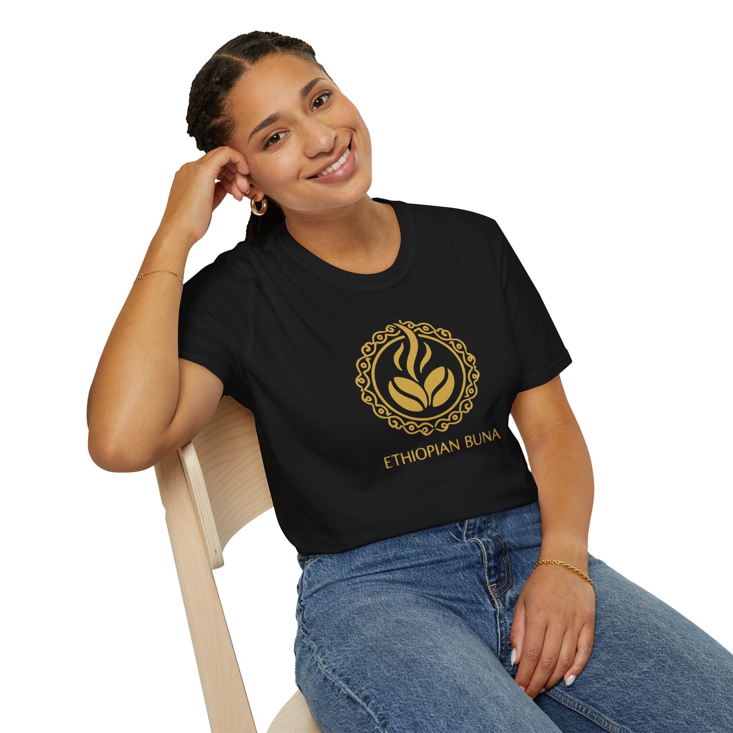A woman wearing a black Ethiopian Buna graphic print t-shirt sitting in a chair