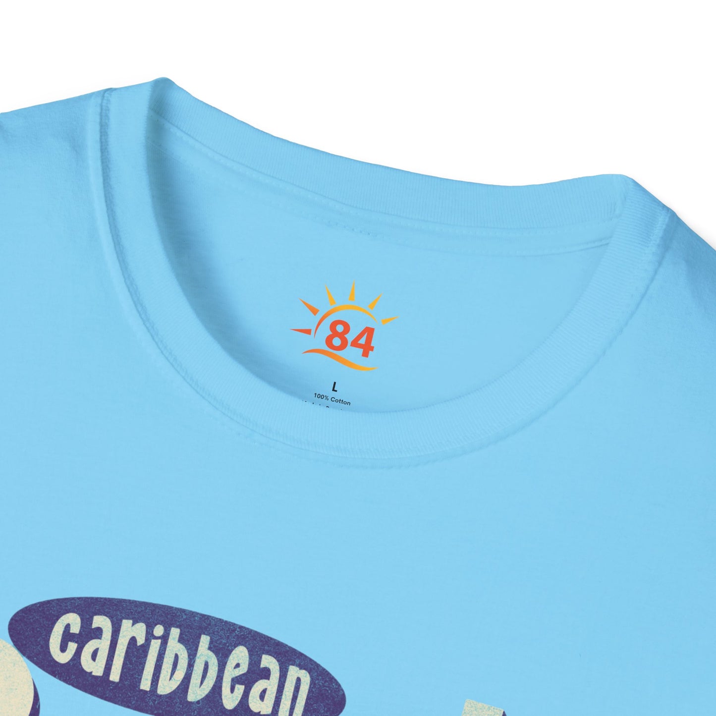 A folded sky blue t-shirt that says Caribbean Sunsets, Rum Punch Dreams with a beach sunset graphic.