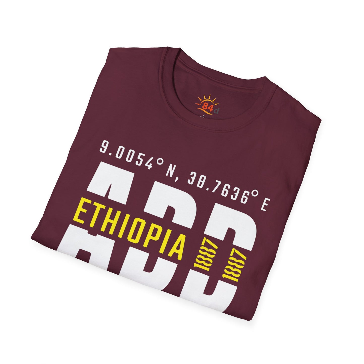 A folded maroon t-shirt with Addis Ababa, Ethiopia, ADD Airport code and coordinates.