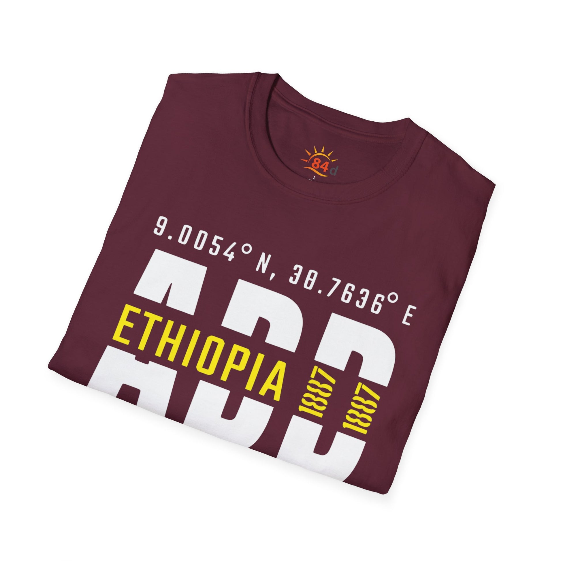 A folded maroon t-shirt with Addis Ababa, Ethiopia, ADD Airport code and coordinates.
