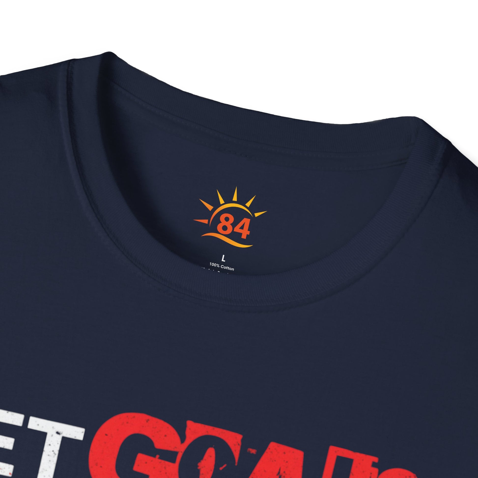 A folded navy blue t-shirt with text, Set Goals Fete Harder on a white background