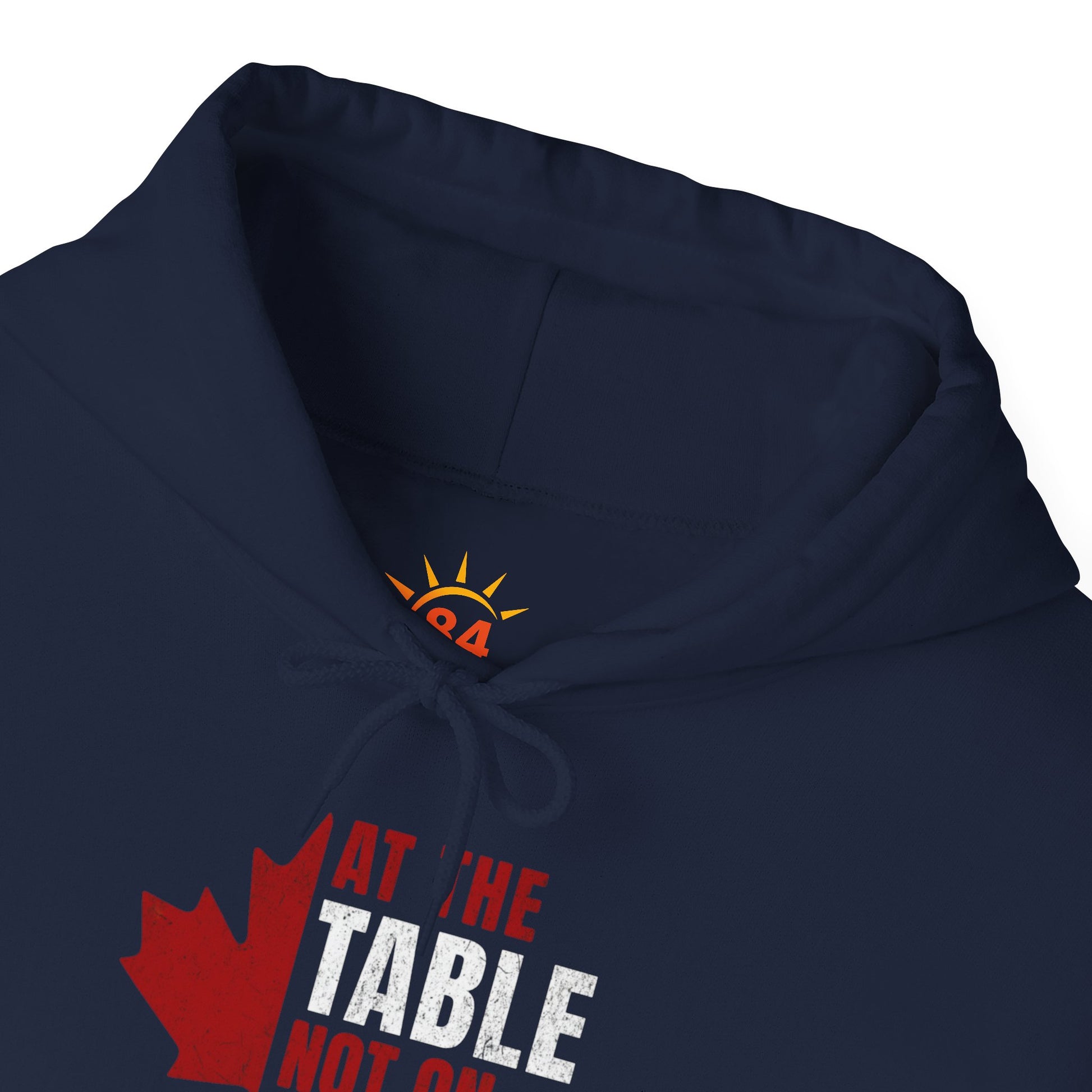 A folded navy blue hoodie with a red and white graphic design. We are at the table not on the menu