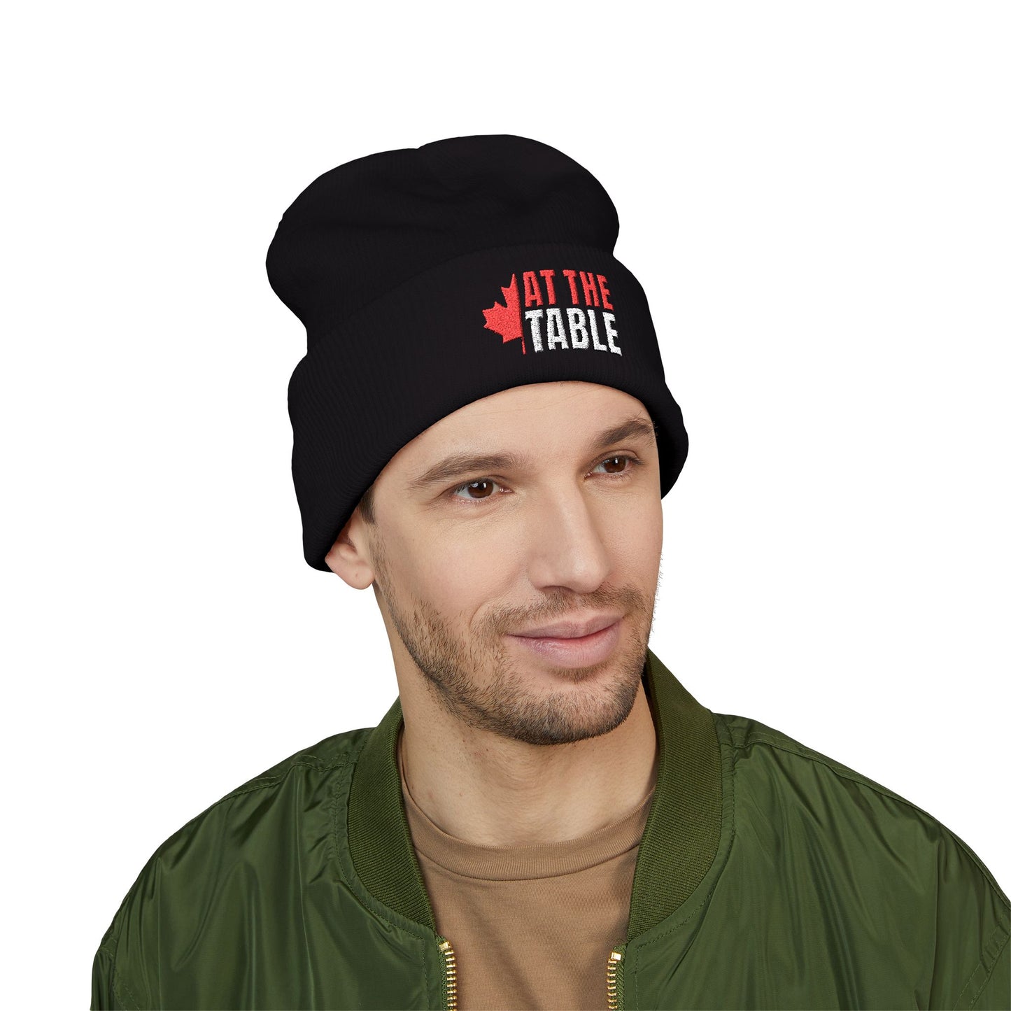 Man wearing a black beanie with 'At The Table' logo on a white background