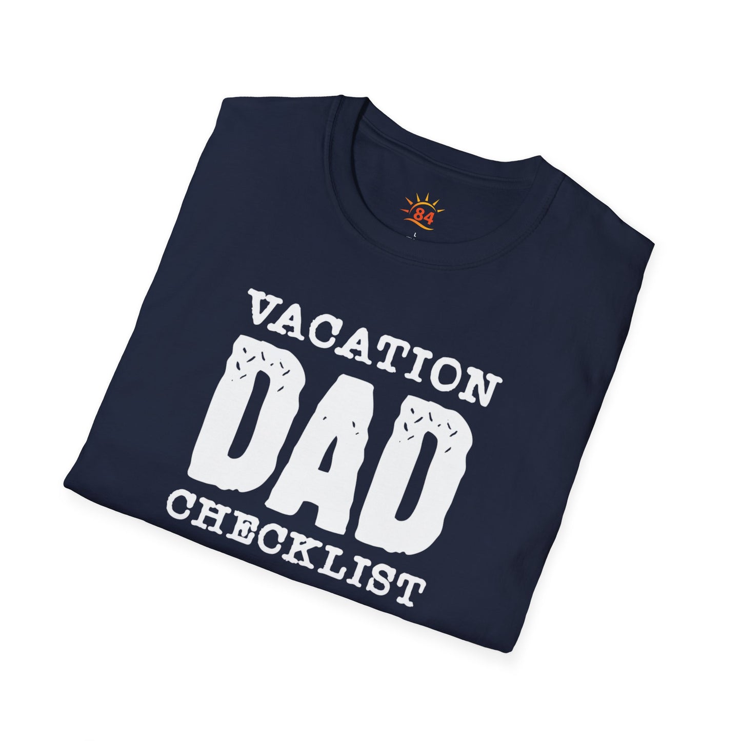 A folded navy blue t-shirt with 'VACATION DAD CHECKLIST' text and bold text and graphics
