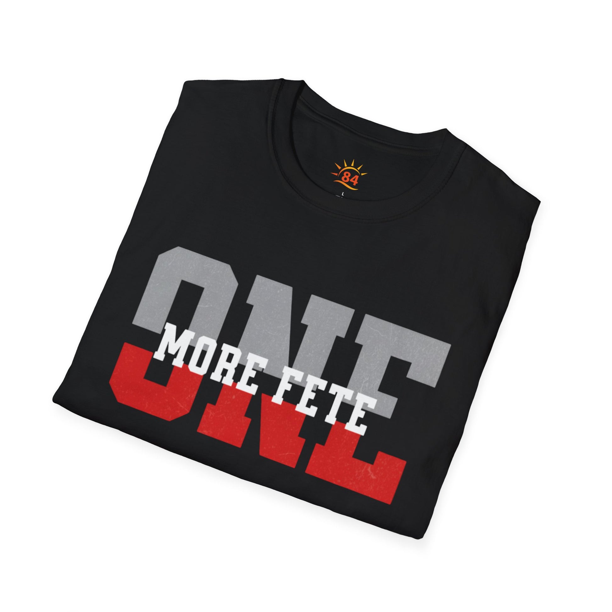 A folded black t-shirt with 'ONE MORE FETE' text on a white background