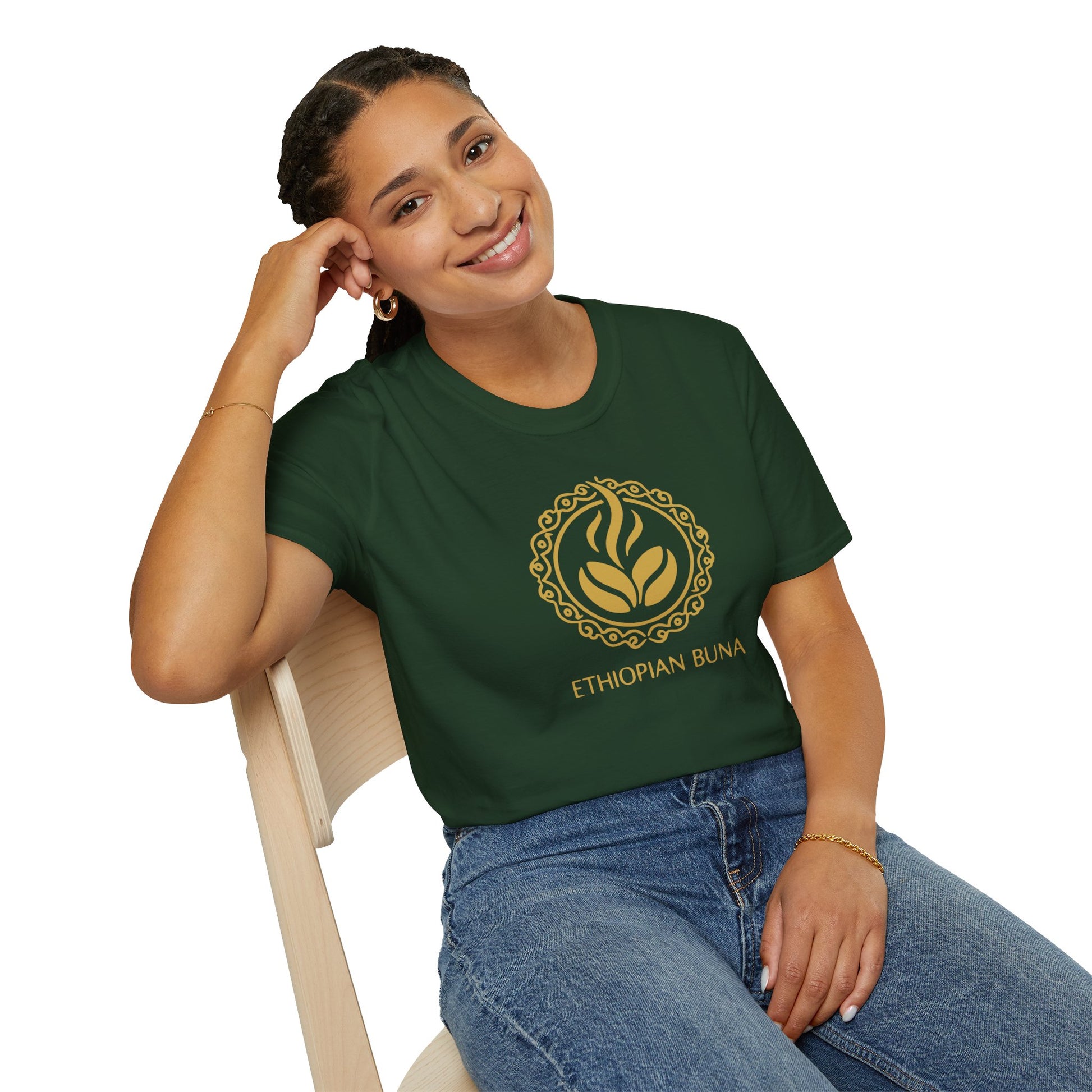 A woman wearing a forest green Ethiopian Buna graphic print t-shirt sitting in a chair