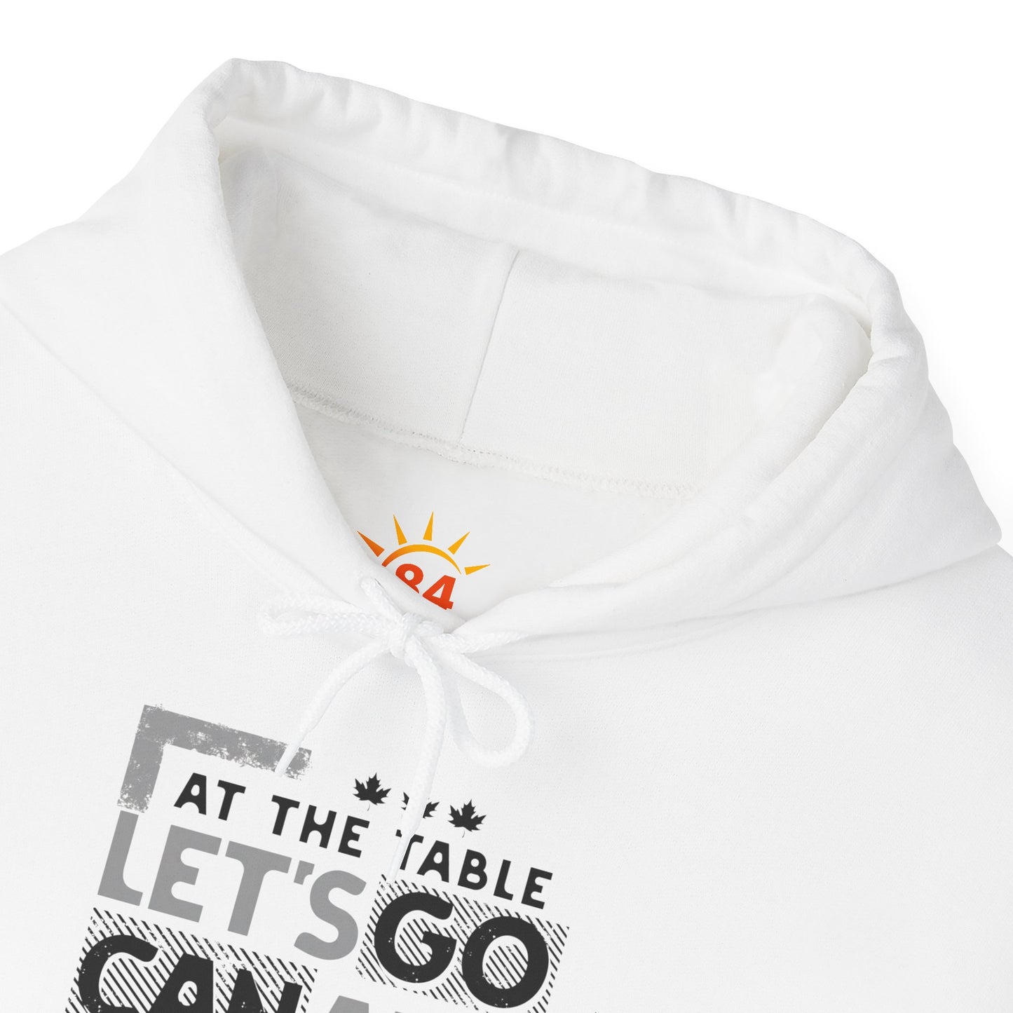 A folded white hoodie with text design, At the table, Let's go Canada, Not on the menu.