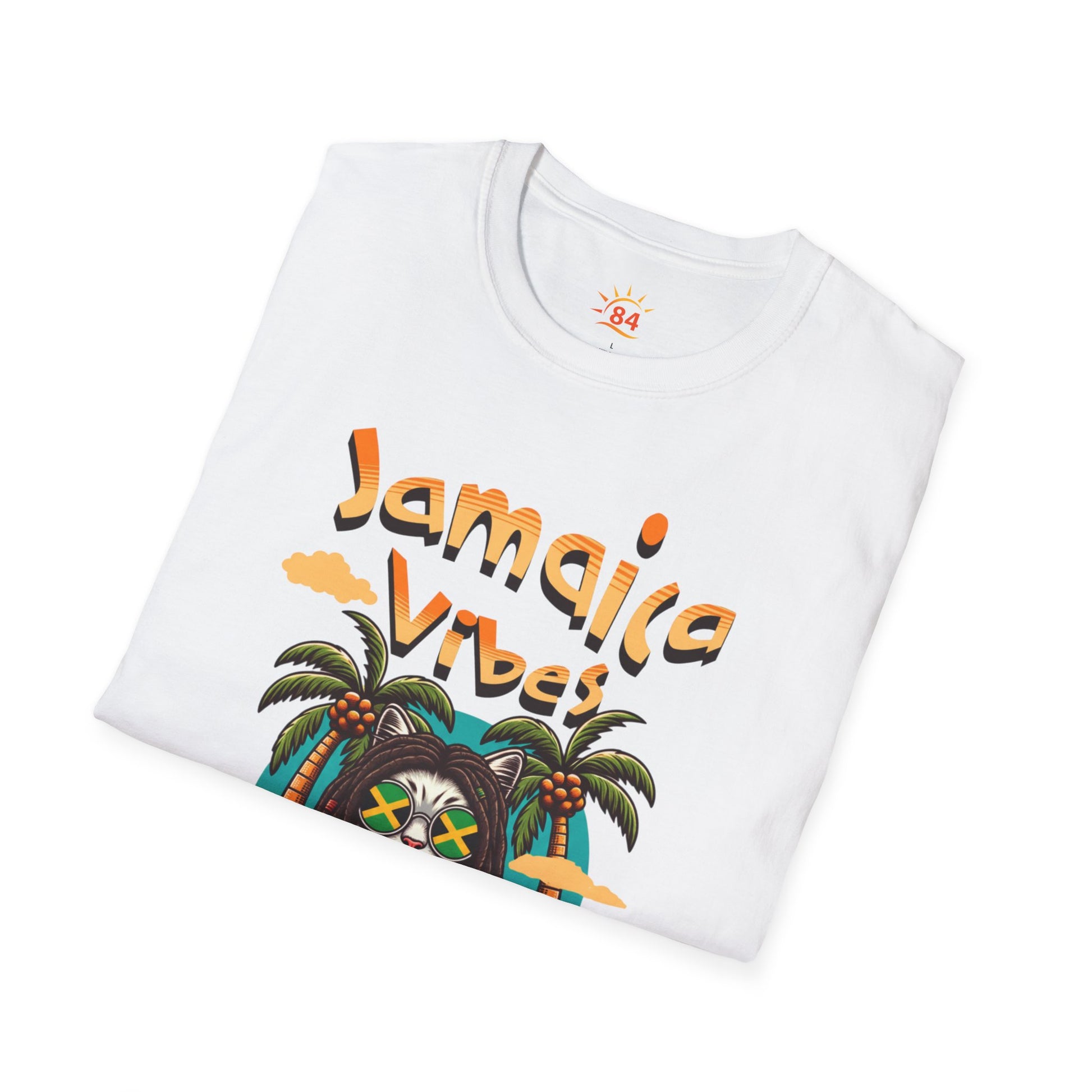 A folded white t-shirt with Jamaica Vibes text and Jamaica flag reggae inspired graphic. 